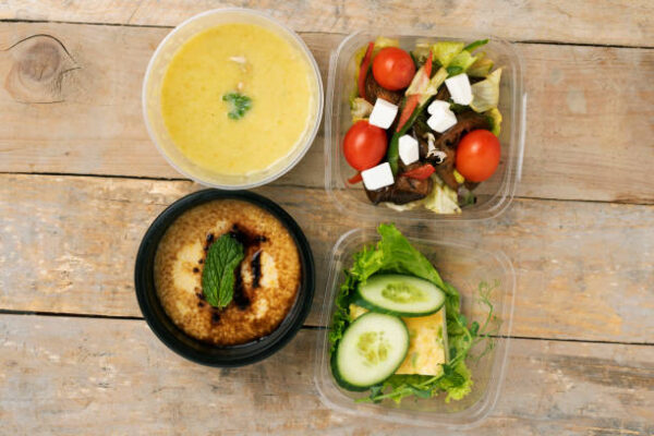 Four boxes with healthy vegan breakfast, flat lay